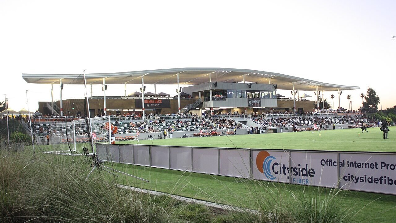 A soccer stadium at dusk during a match