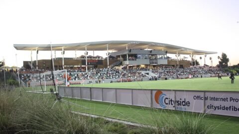 A soccer stadium at dusk during a match