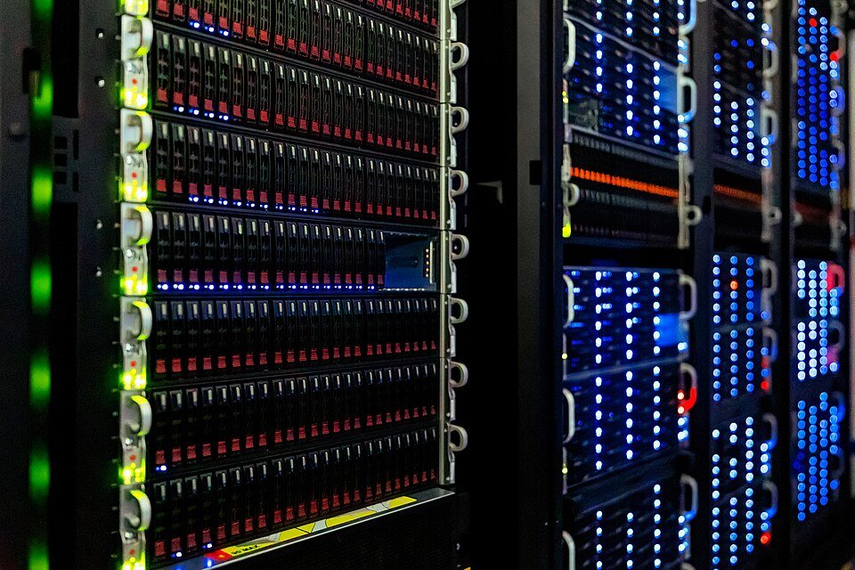 Rows of computer server racks with blinking lights in a data center
